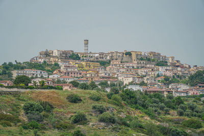 Buildings in town against clear sky