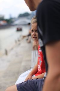 Side view of boy sitting outdoors