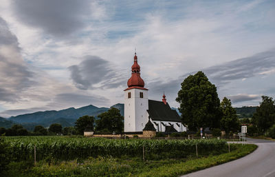 Church by tree against sky