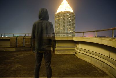 Rear view of man standing in city