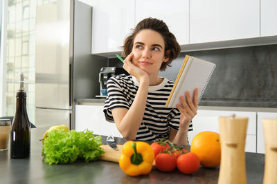 Portrait of young woman using mobile phone at home