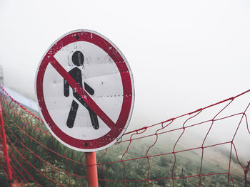 Road sign don't walk in the fog of clouds