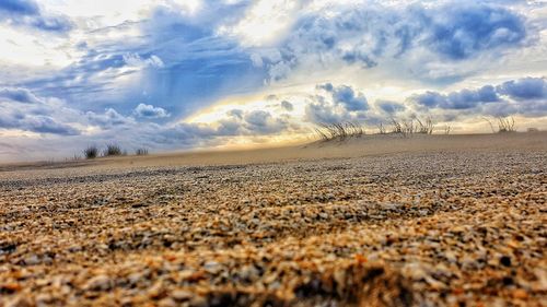 Scenic view of land against sky during sunset