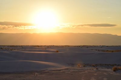 Scenic view of beach against sky during sunset