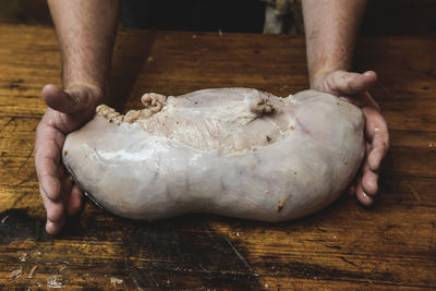 Cropped hands of person preparing food on table