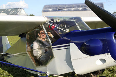 Beautiful woman sitting in propeller airplane