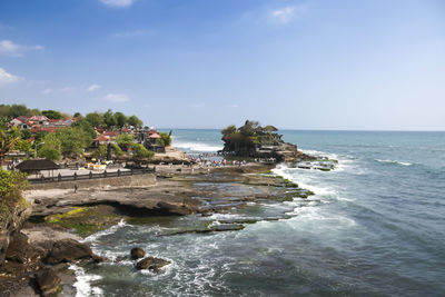 Scenic view of rocks on beach against sky