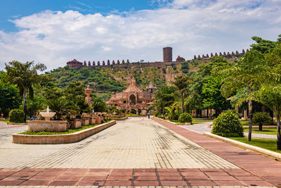 Artistic carved red stone jain temple with bright blue sky at morning from unique angle