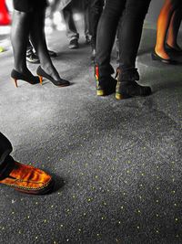 Low section of man standing on road