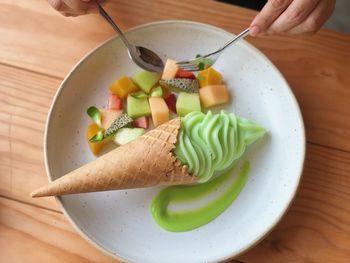 High angle view of person with vegetables on plate