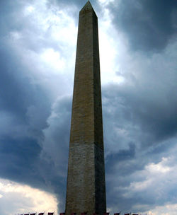 Low angle view of building against cloudy sky