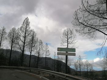 Low angle view of road sign against sky