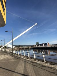 Bridge over road against blue sky