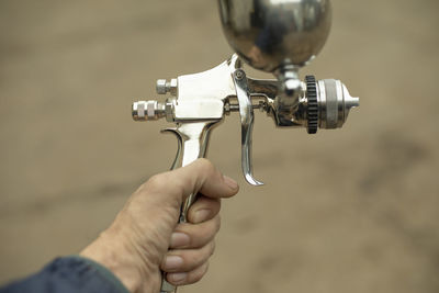 Close-up of hand holding faucet