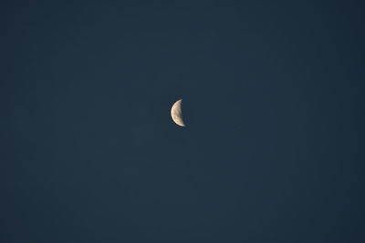 Low angle view of moon against clear sky at night