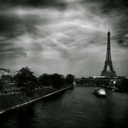 Eiffel tower against cloudy sky