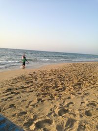 Scenic view of beach against clear sky