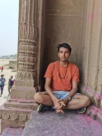 Indian guy sitting in varanasi holi time