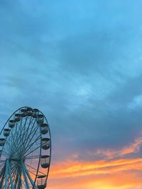 Low angle view of ferris wheel against sky