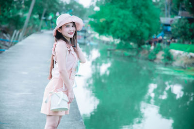 Portrait of smiling woman standing in water