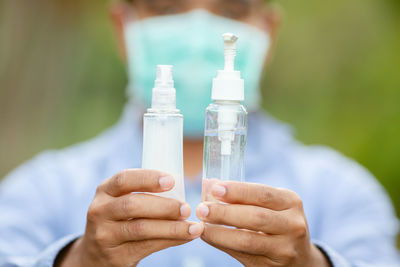 Close-up of human hand holding bottle