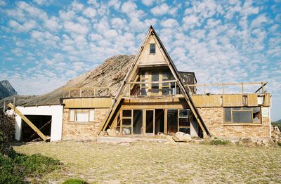 Exterior of house on field against sky