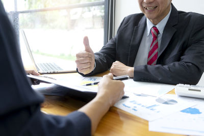 People working on table in office