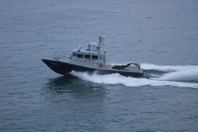 Ship sailing in sea against sky