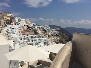 View of cityscape by sea against sky