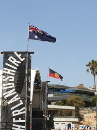 Low angle view of flags flag against clear sky