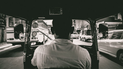 Rear view of man sitting in bus