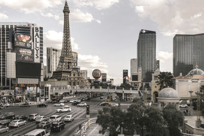 View of city buildings against cloudy sky