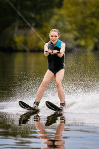 Full length of man splashing water in lake