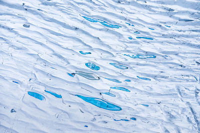 Picturesque scenery of massive glacier surface with shiny blue ice located in vatnajokull national park in iceland