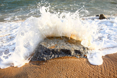 High angle view of waves splashing on shore