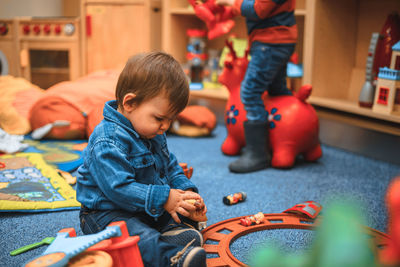 Boy playing with toy car