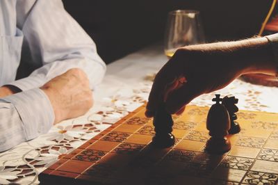 Close-up of people playing chess