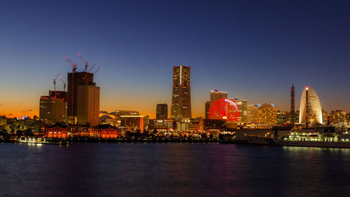 Illuminated city at waterfront