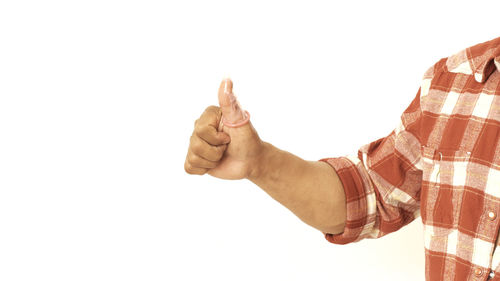 Midsection of man with arms raised against white background