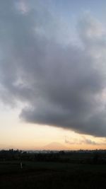 Scenic view of field against sky during sunset