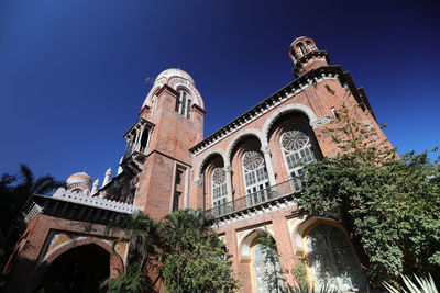 Low angle view of historic building against clear blue sky