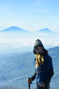 Man standing on mountain against sky