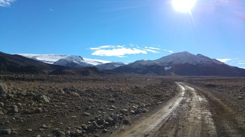 Scenic view of snowcapped mountains against blue sky