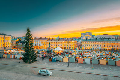 High angle view of buildings in city against sky during sunset