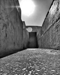 Surface level of narrow wall by historic building against sky