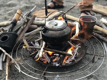 High angle view of teapot on bonfire