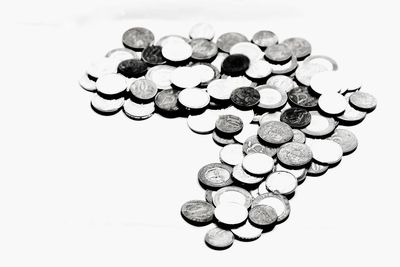 High angle view of coins on white background