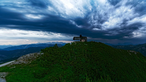 Scenic view of building and mountains against sky