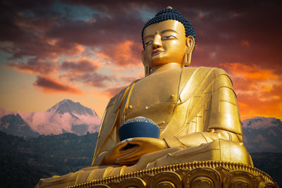 Low angle view of statue against sky during sunset