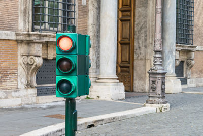 Close-up of street light on sidewalk